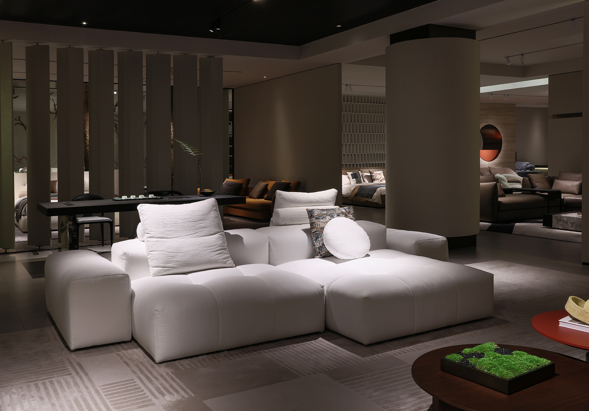 Immersive showroom space with multiple soft decor furniture settings